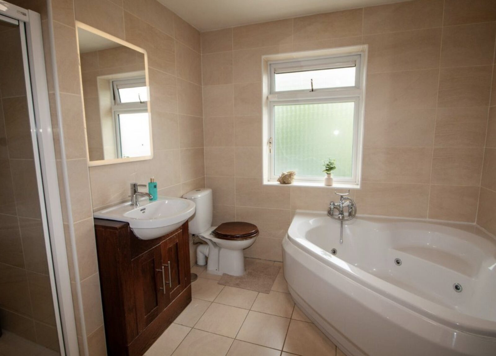 Family bathroom with corner bath